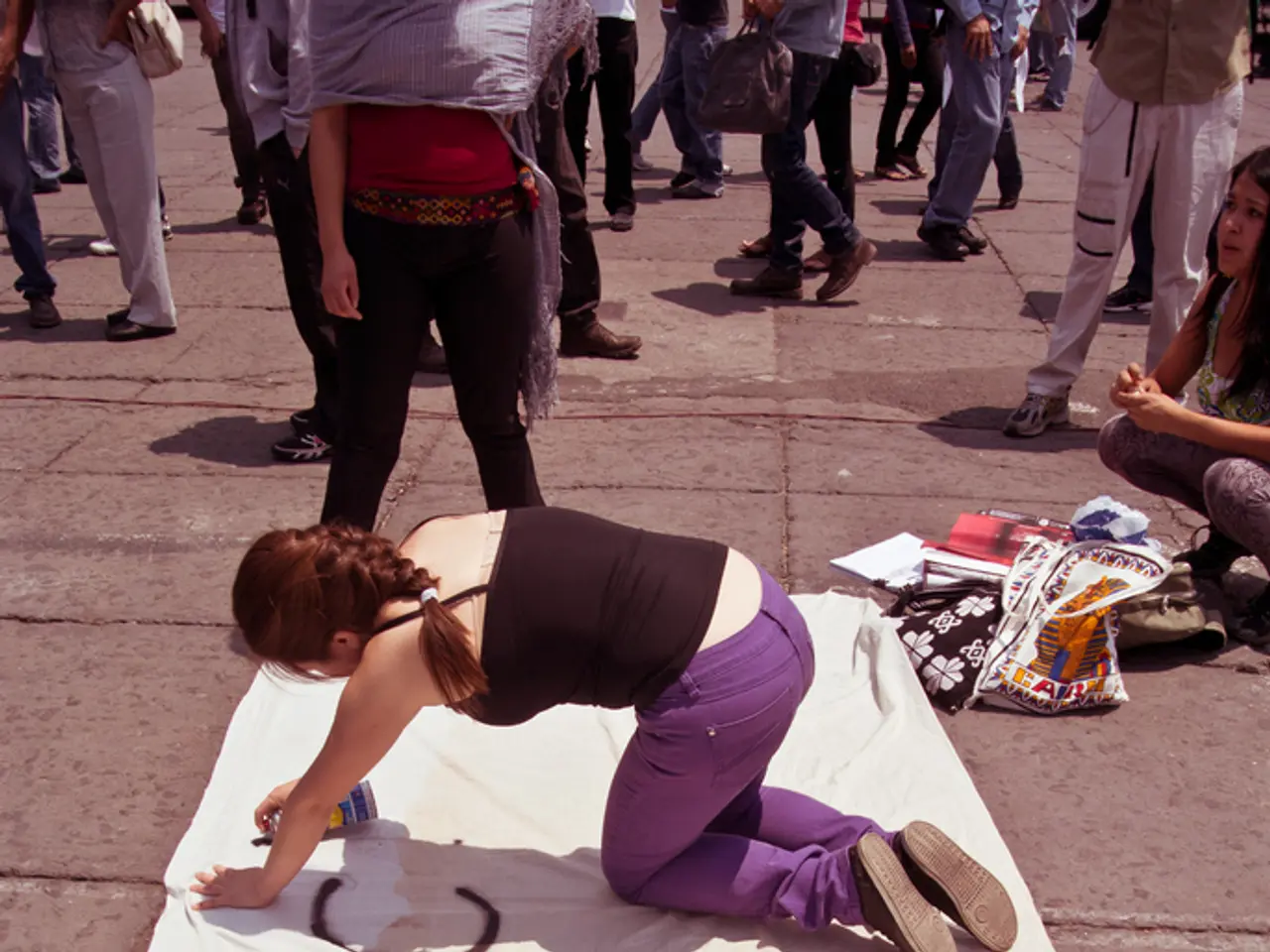 In this image there is a girl in the middle who is kneeling down on the floor and painting on the...