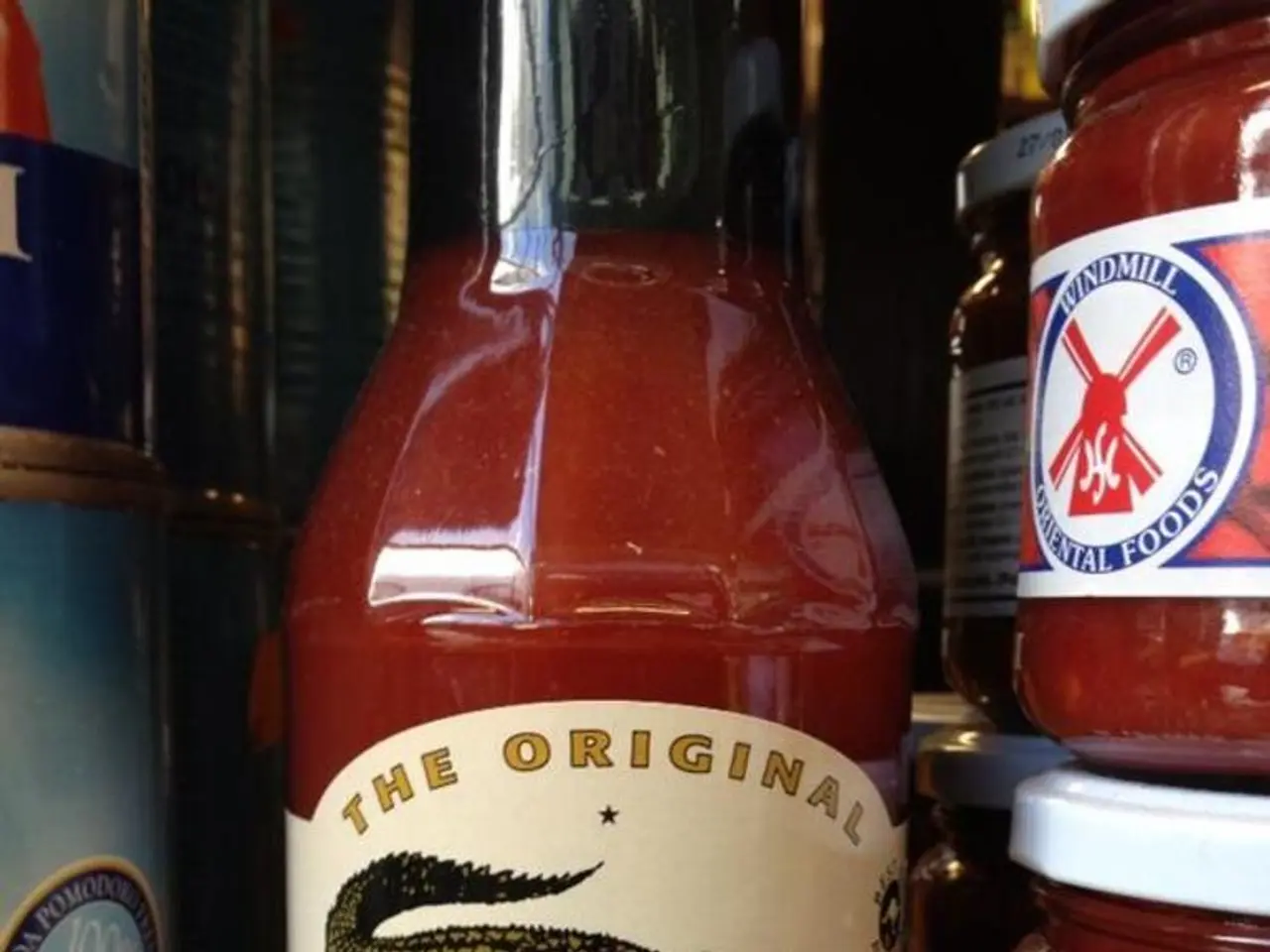 A sauce bottle and some glass containers are placed by the side.