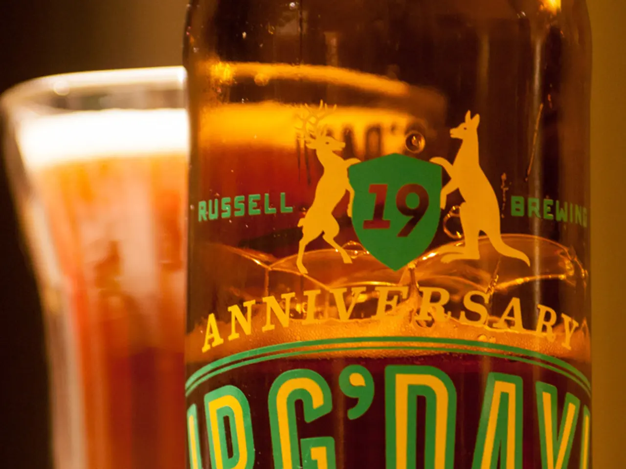 There is a wine bottle and glass of wine on table.