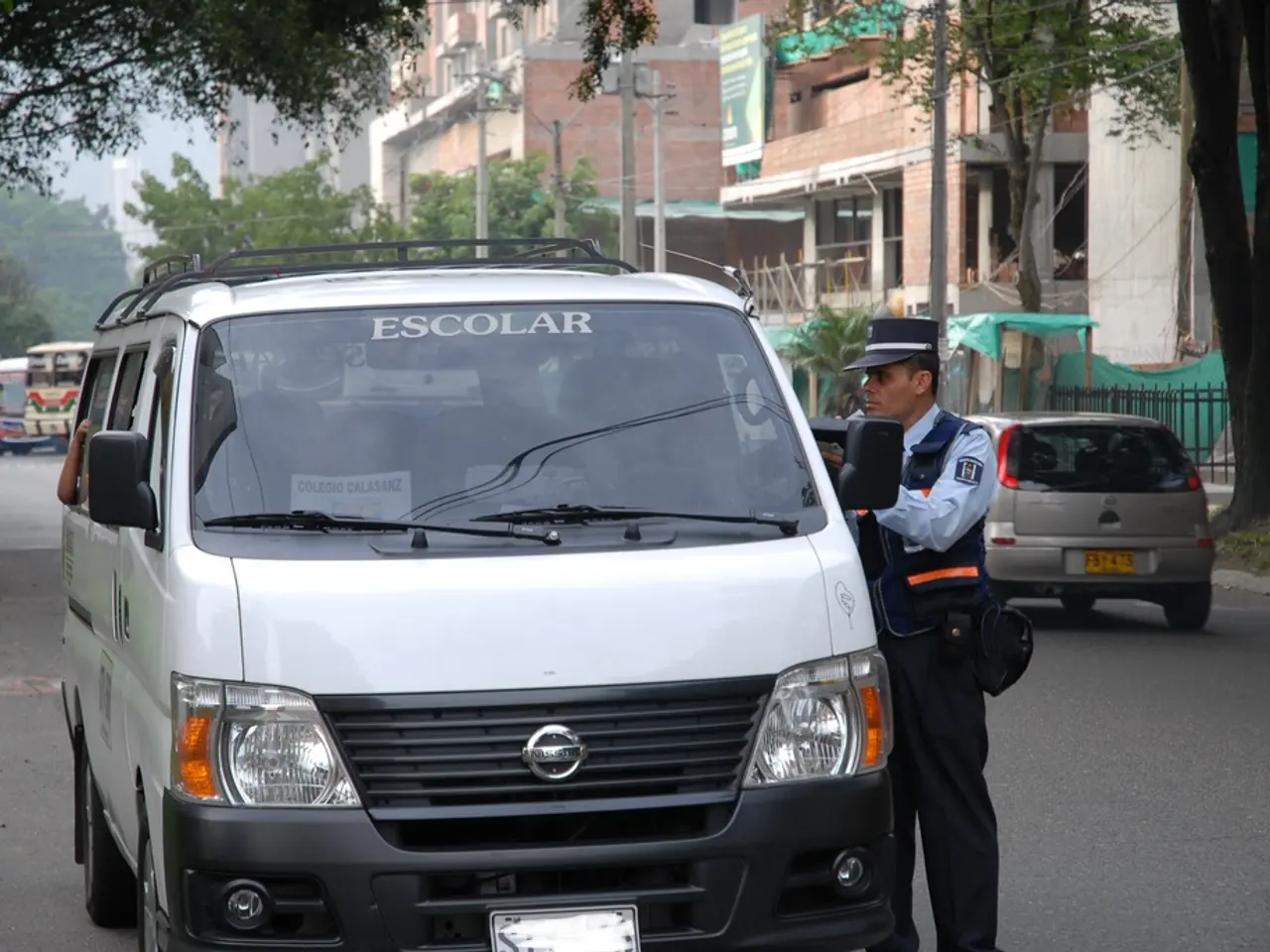 As we can see there are many vehicles on the road and the police man is talking to the person...