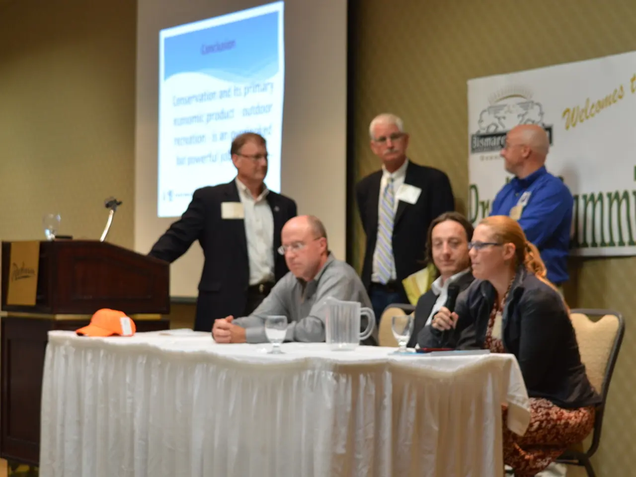 In this picture here we see 6 persons present, of them 3 are sitting and other 3 are standing. The...