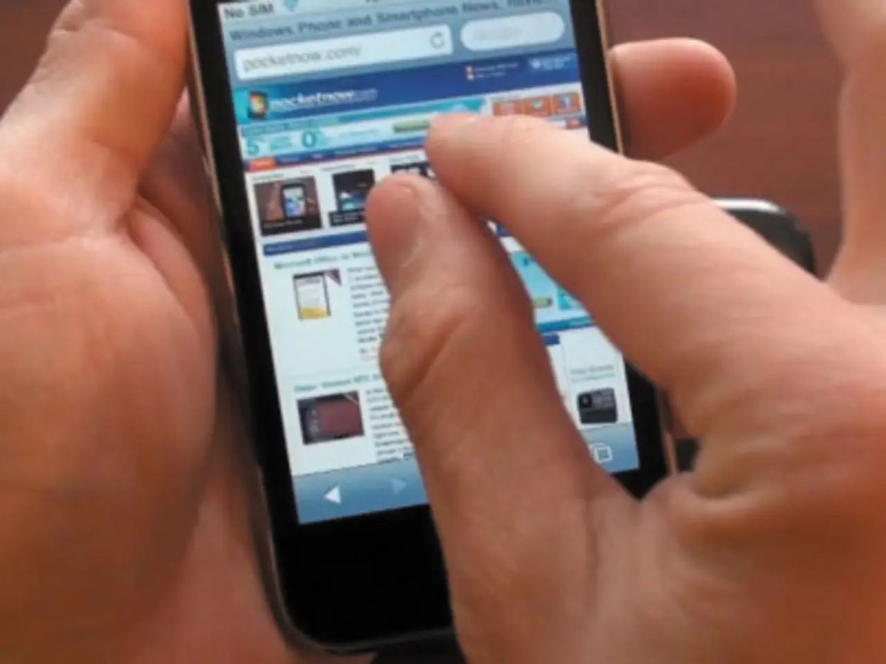 In this picture there is a person holding the cellphone. On the screen there is text.