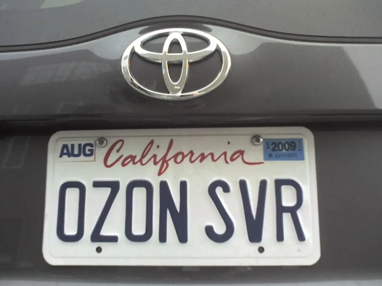 In this image there is a car with a number plate on it and there is a text on the number plate.