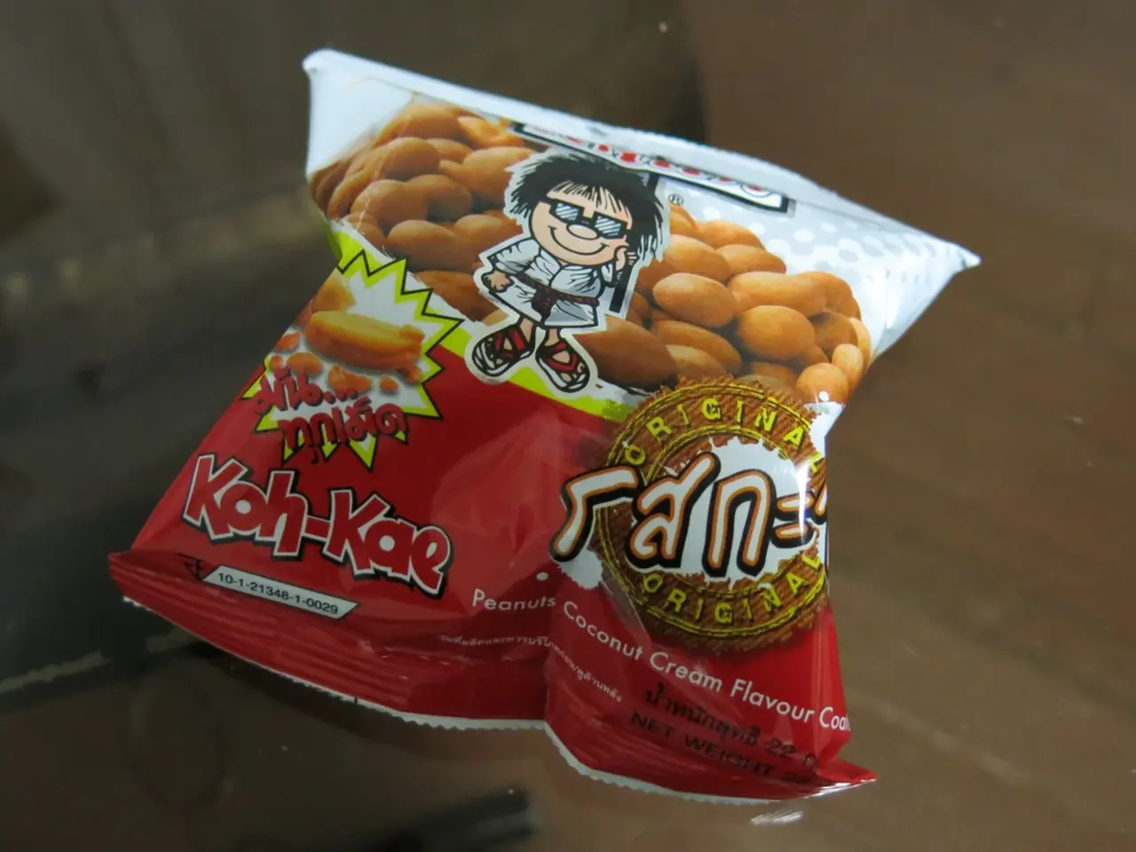 Here I can see a food packet on which there is some text and a cartoon image. This is placed on a...