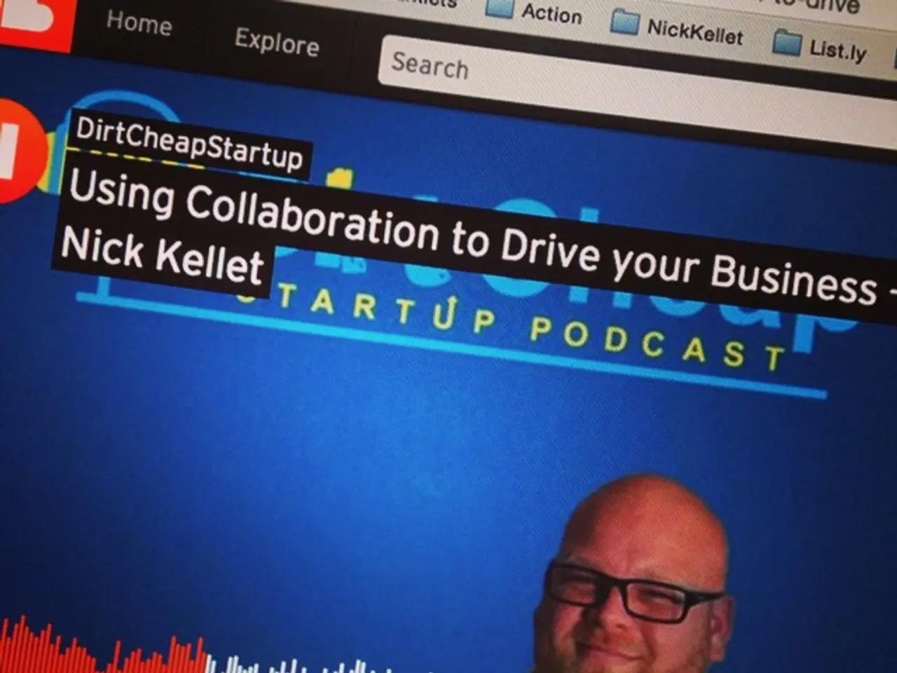 In the picture I can see a web page. In the web page I can see a man who is wearing spectacles and...