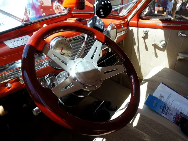 This is an inside view of a vehicle and here we can see a steering and there are papers on the seat...