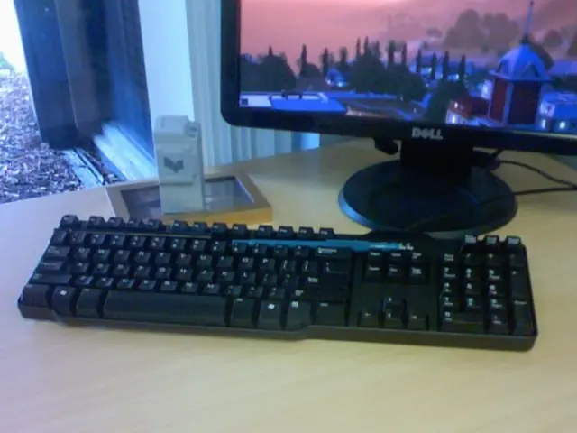 In this image I can see a phone, a keyboard and a monitor.