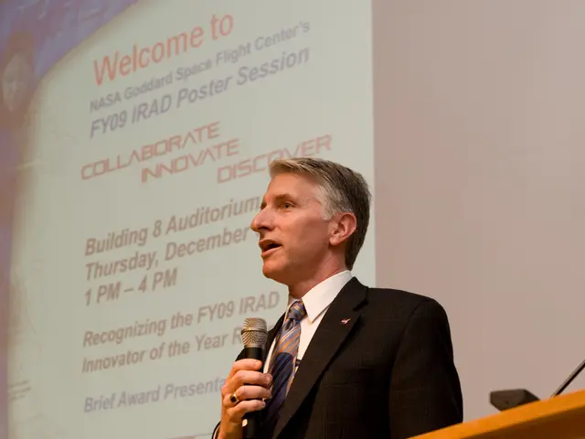 In this image i can see a man and holding the microphone, in the bottom right corner there is an...