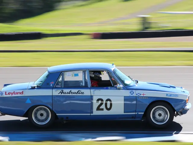 In this image I can see a car in blue color, in side I can see a person sitting and I can see...