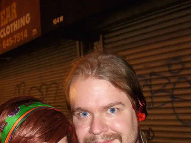 In the picture we can see a man and a woman standing together and a man is in the blue shirt and...