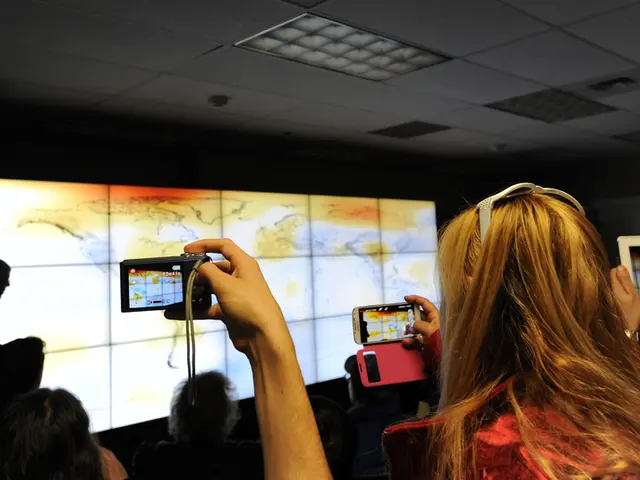 In this picture I can see a designed screen on the board, some people are taking pictures.