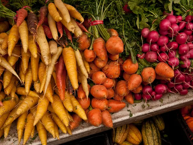 Here I can see some root vegetables along with the plants and leaves. These are placed on a table....